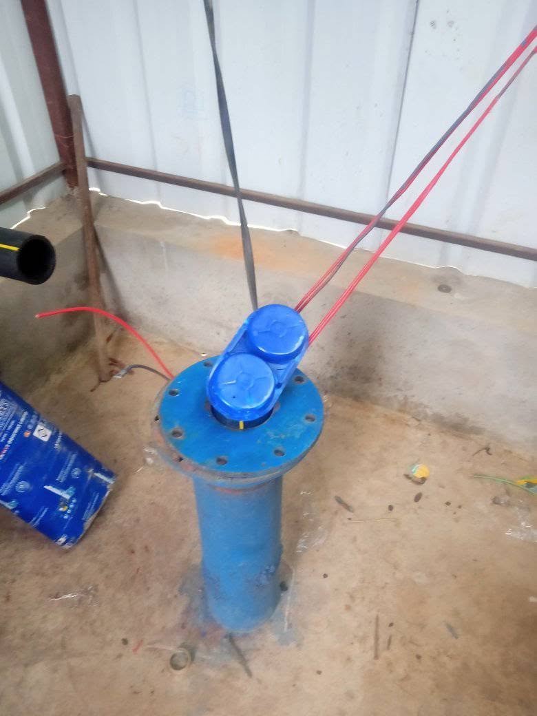 Blue pump assembly inside a farm structure